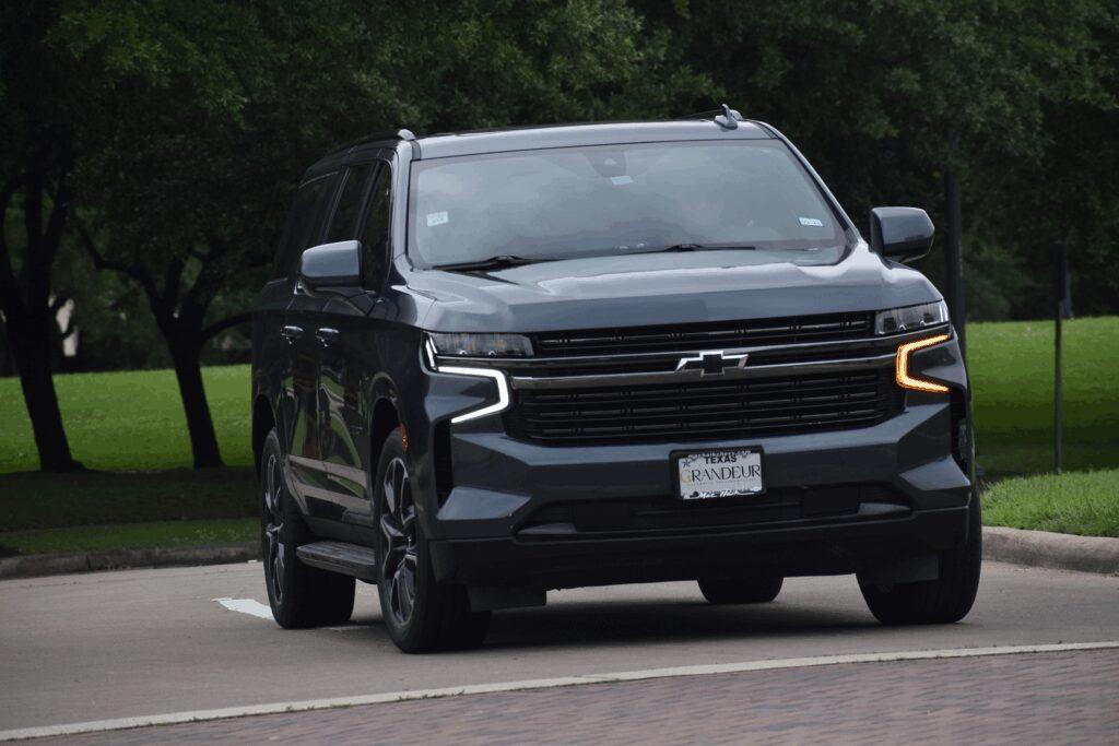 A Chevy Suburban SUV cruising near a nature reserve